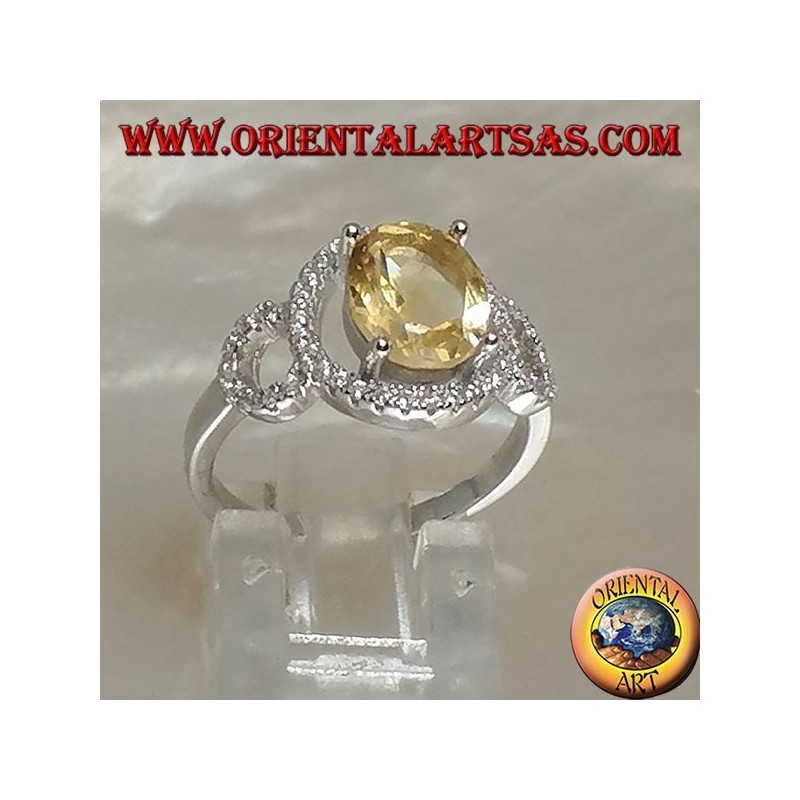 Silver ring with oval natural yellow topaz set on a three circle of zirconia setting