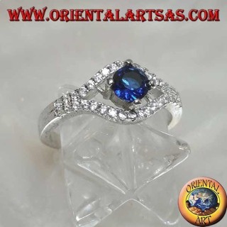 Silver ring in the shape of an eye with a set round synthetic sapphire and contour zircons