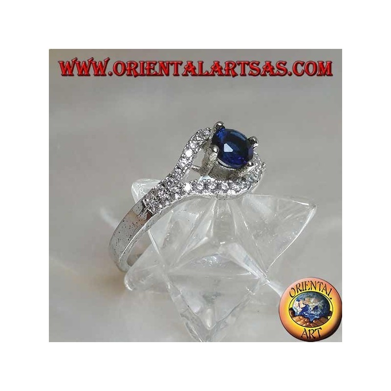 Silver ring in the shape of an eye with a set round synthetic sapphire and contour zircons