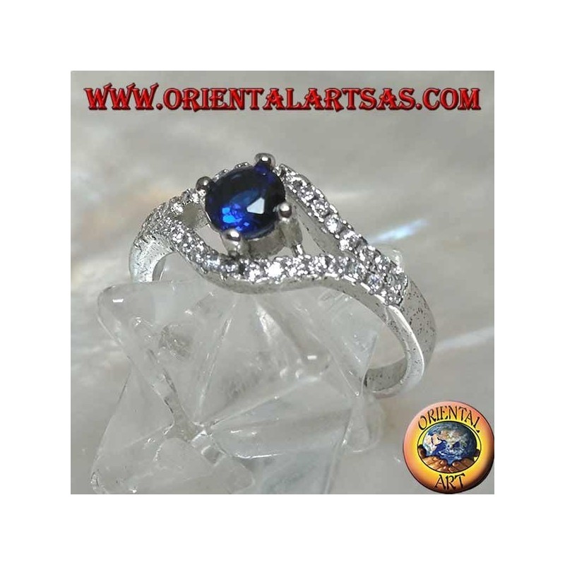 Silver ring in the shape of an eye with a set round synthetic sapphire and contour zircons