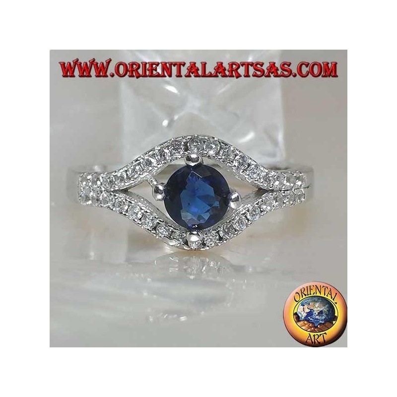 Silver ring in the shape of an eye with a set round synthetic sapphire and contour zircons