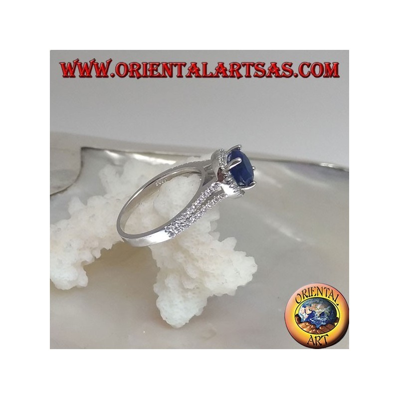 Anello in argento con zaffiro sintetico tondo incastonato contornato da zirconi sopraelevato