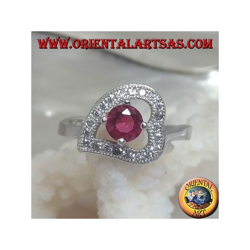 Silver ring in the shape of a horizontal heart with a synthetic round ruby set surrounded by zircons