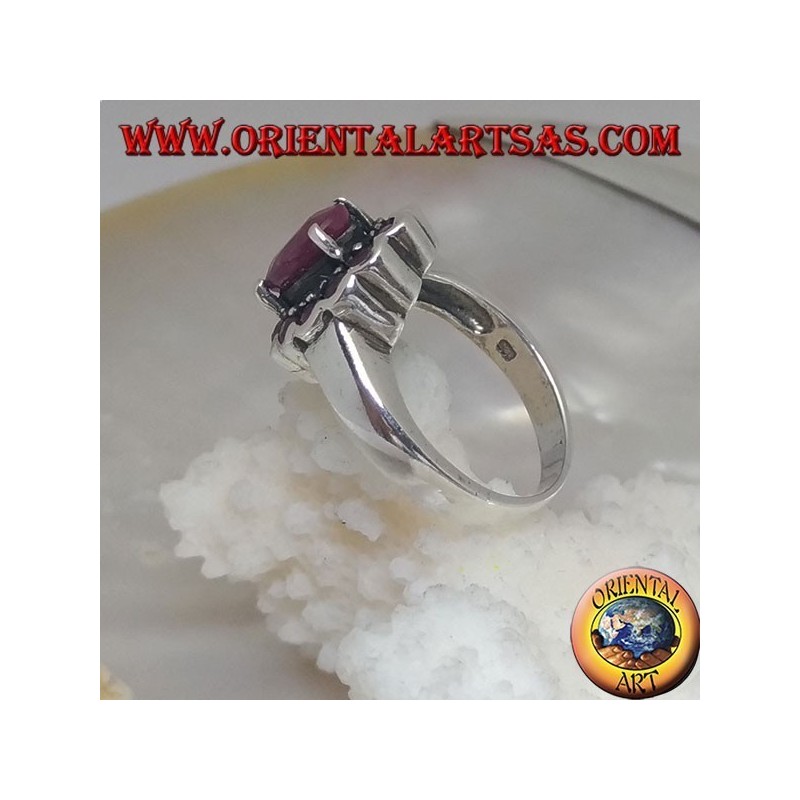 Anillo de plata con rubí natural ovalado, rodeado de pequeños rubíes redondos.