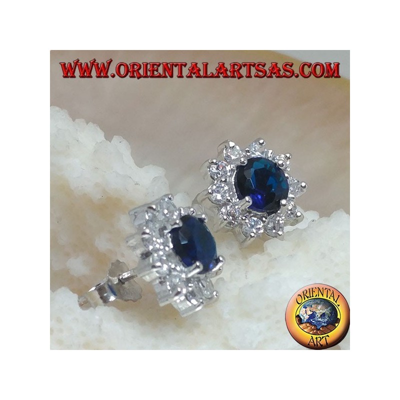 Silver lobe earrings with round synthetic sapphire set surrounded by zircons