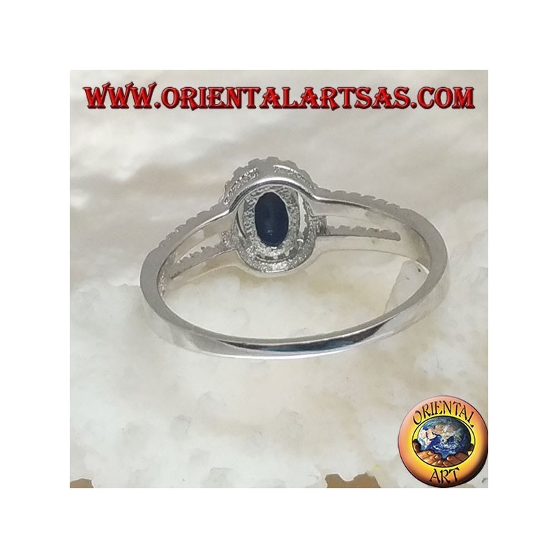 Silver ring with oval synthetic sapphire set surrounded by zircons and two lateral lines