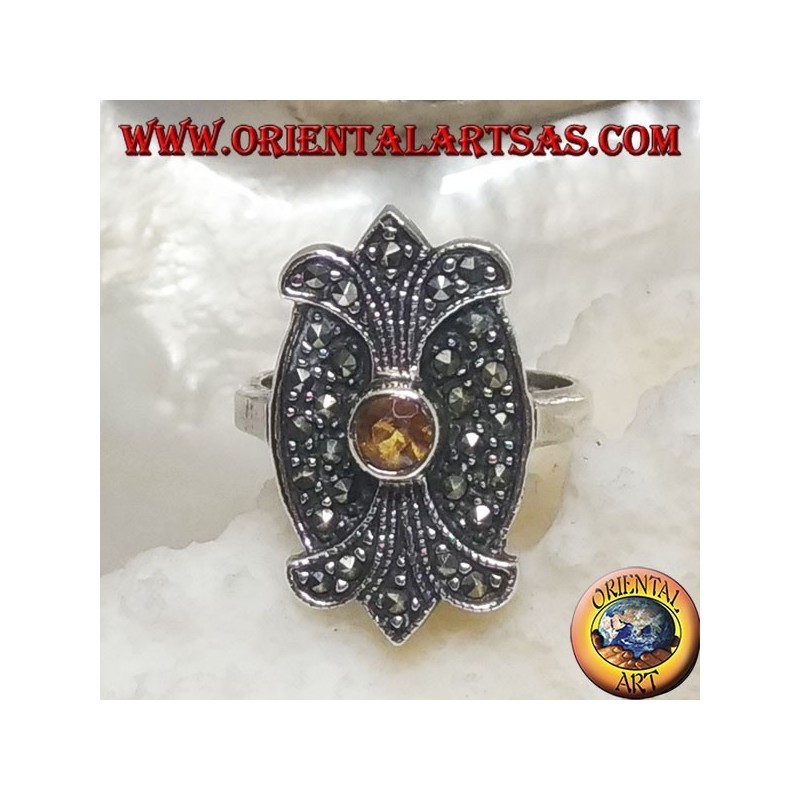 Silver ring with round yellow topaz on oval shield with double mirror lily studded with marcasite