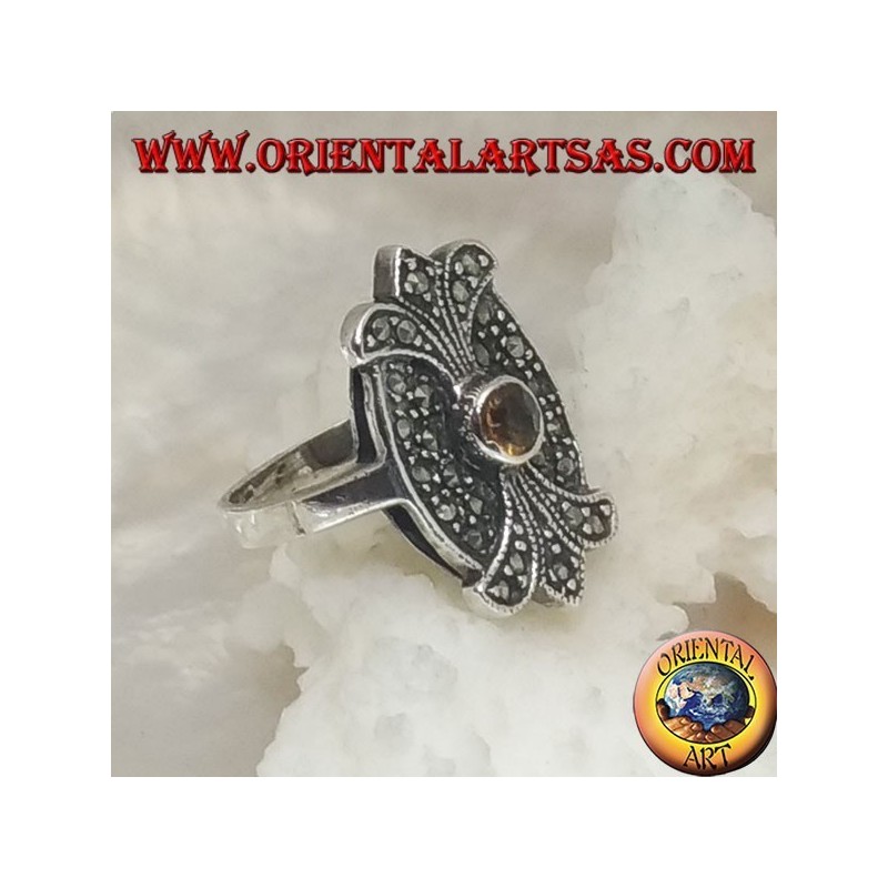 Silver ring with round yellow topaz on oval shield with double mirror lily studded with marcasite