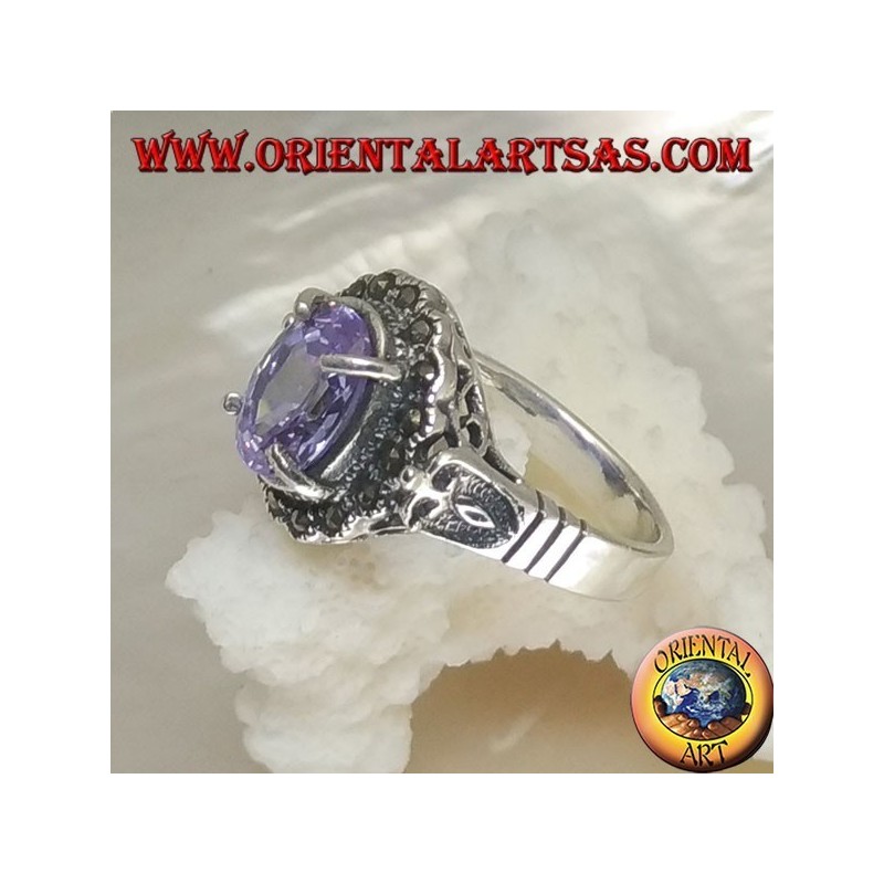 Silver ring with oval amethyst colored zircon set surrounded by marcasite and openwork on the sides