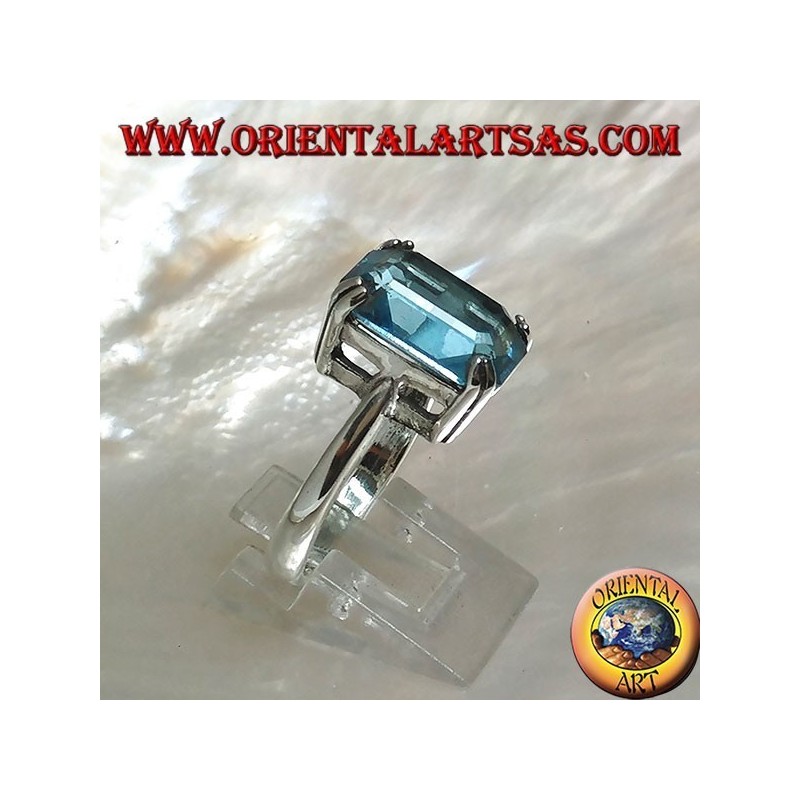 Silver ring with rectangular blue topaz set with a claw setting