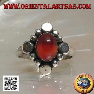 Silver ring with oval cabochon carnelian surrounded by alternating studs and balls