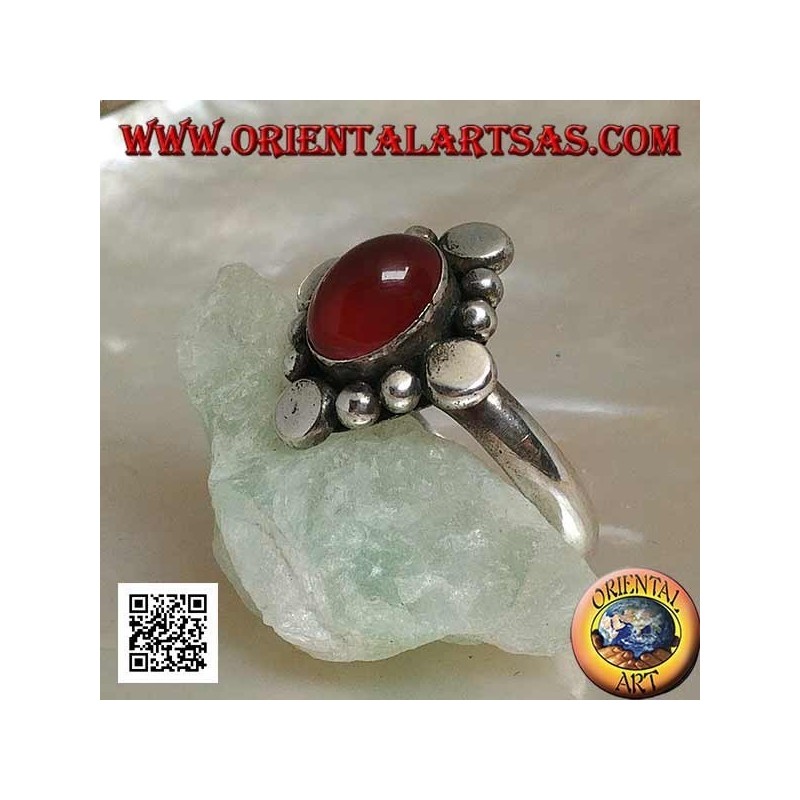 Silver ring with oval cabochon carnelian surrounded by alternating studs and balls