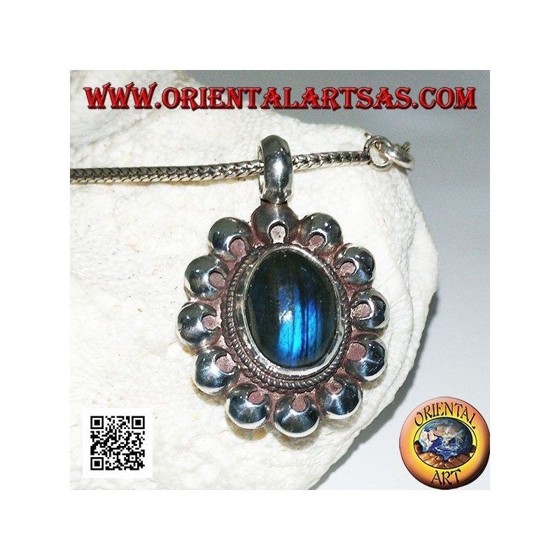 Silver pendant with oval blue fluorescent labradorite cabochon surrounded by perforated discs