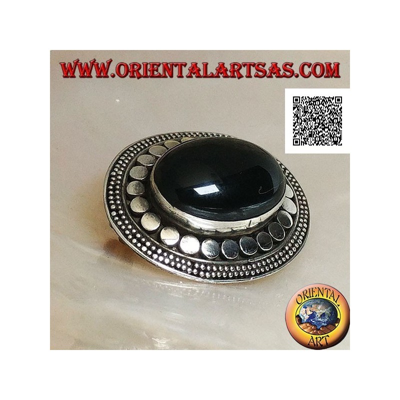 Silver brooch with large oval onyx cabochon surrounded by discs and two strings of dots