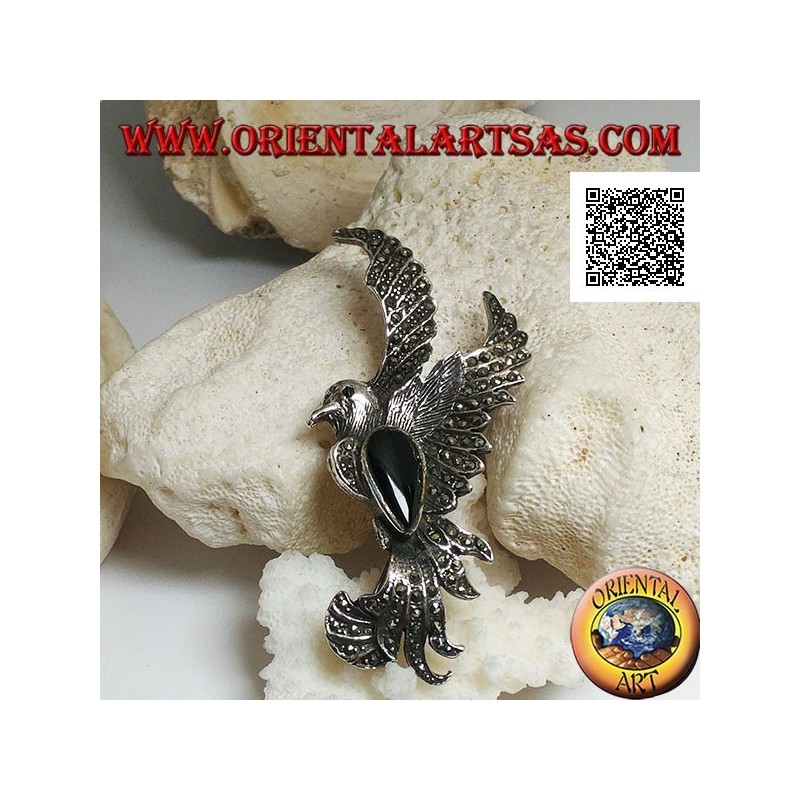 Silver brooch in the shape of a phoenix in flight in profile studded with marcasite and with a drop of onyx