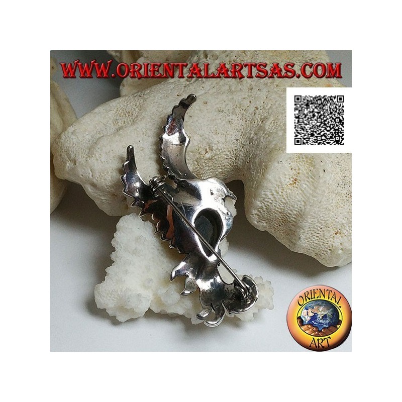 Broche en argent en forme de phénix en vol de profil parsemé de marcassite et d'une goutte d'onyx