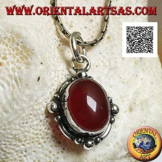 Silver pendant with oval cabochon carnelian surrounded by silver with a ball on the four cardinal points