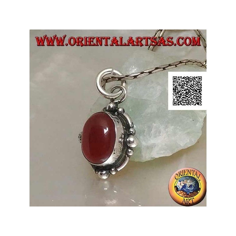 Silver pendant with oval cabochon carnelian surrounded by silver with a ball on the four cardinal points