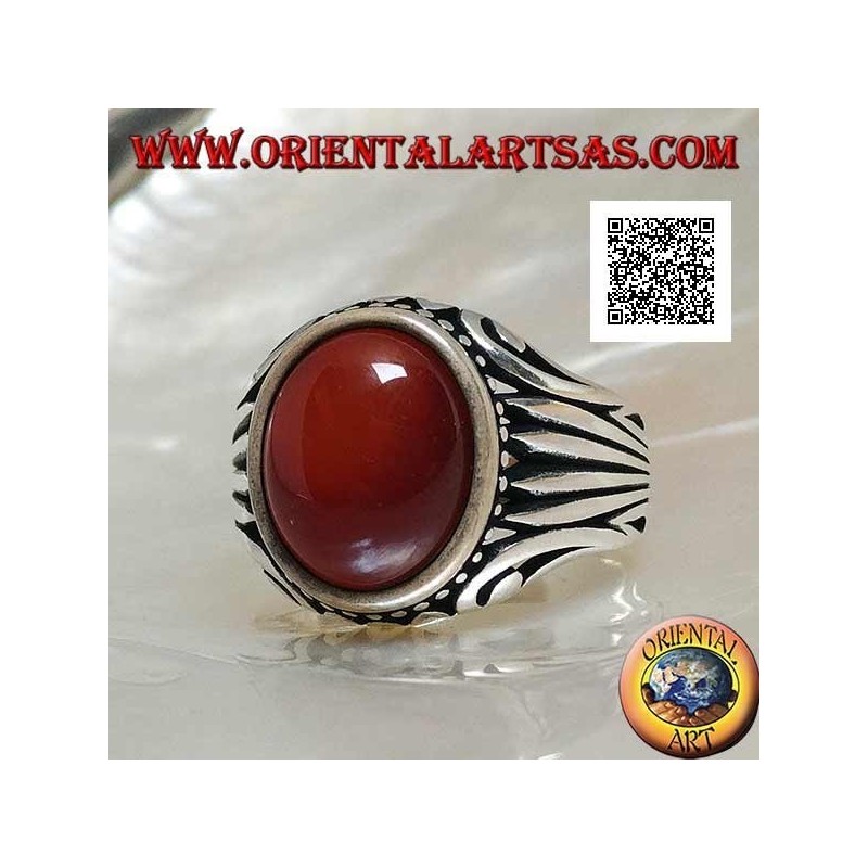 Silver ring with oval cabochon carnelian surrounded by dots and stripes engraved on the sides