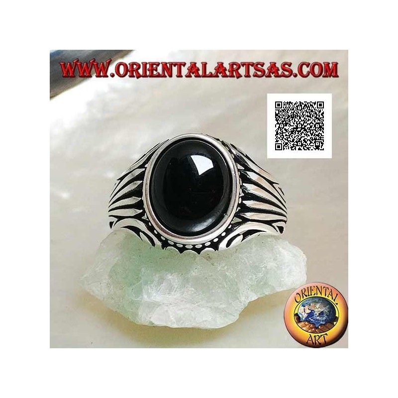 Silver ring with oval onyx cabochon surrounded by dots and stripes engraved on the sides