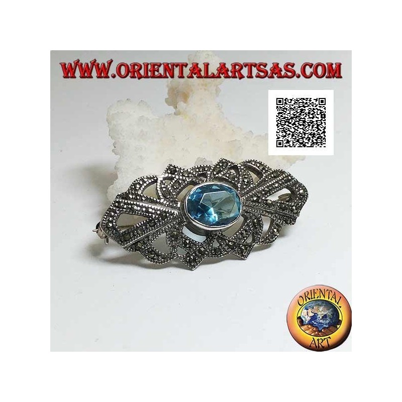 Broche de plata con topacio azul ovalado y decoración calada tachonada con marcasita