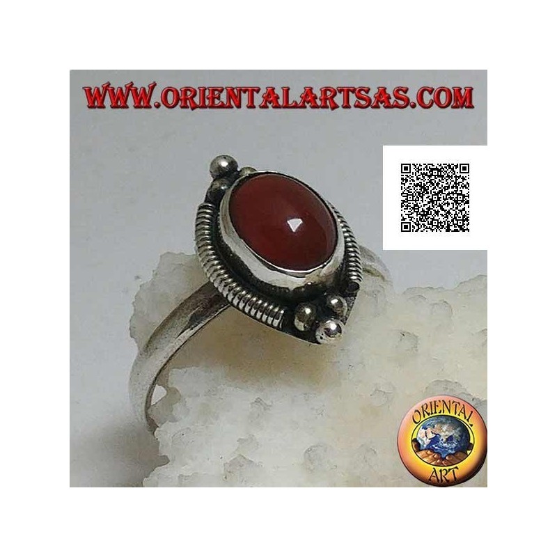 Silver ring with oval cabochon carnelian surrounded by stripes and trio of balls above and below