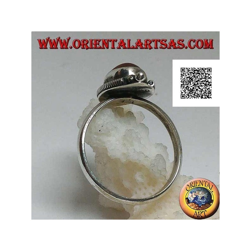 Silver ring with oval cabochon carnelian surrounded by stripes and trio of balls above and below