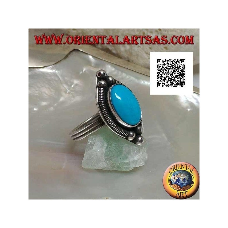 Silver ring with cabochon oval turquoise surrounded by interweaving on a plate and three balls above and below