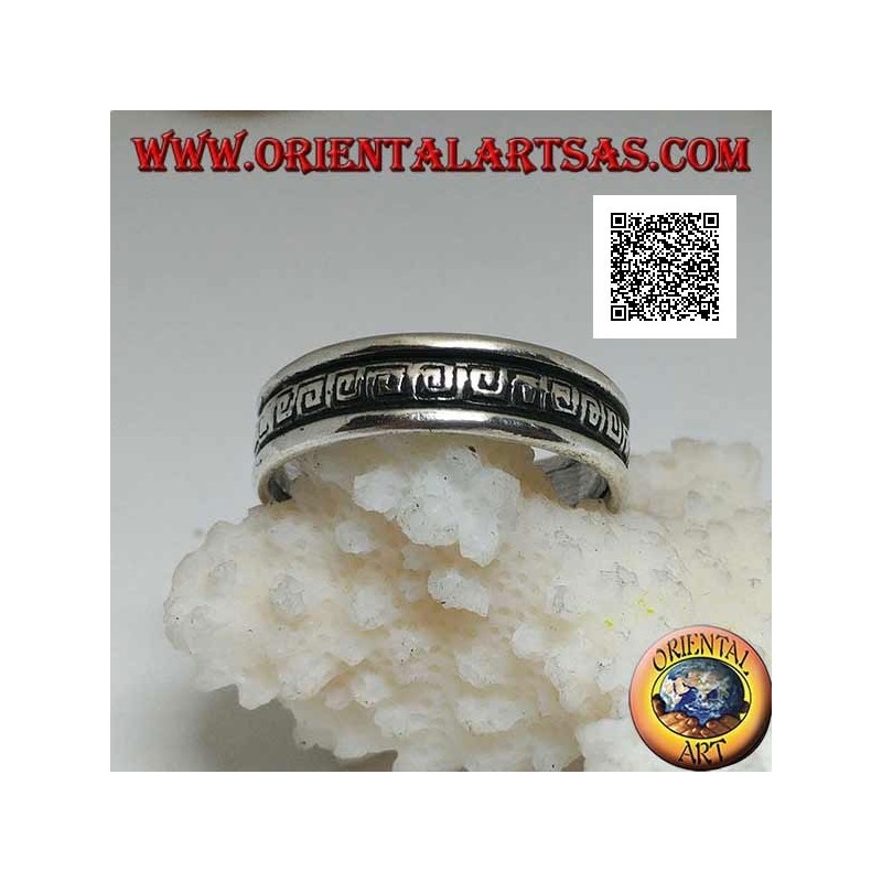 Silver wedding ring with a series of spiral labyrinths engraved in the central part