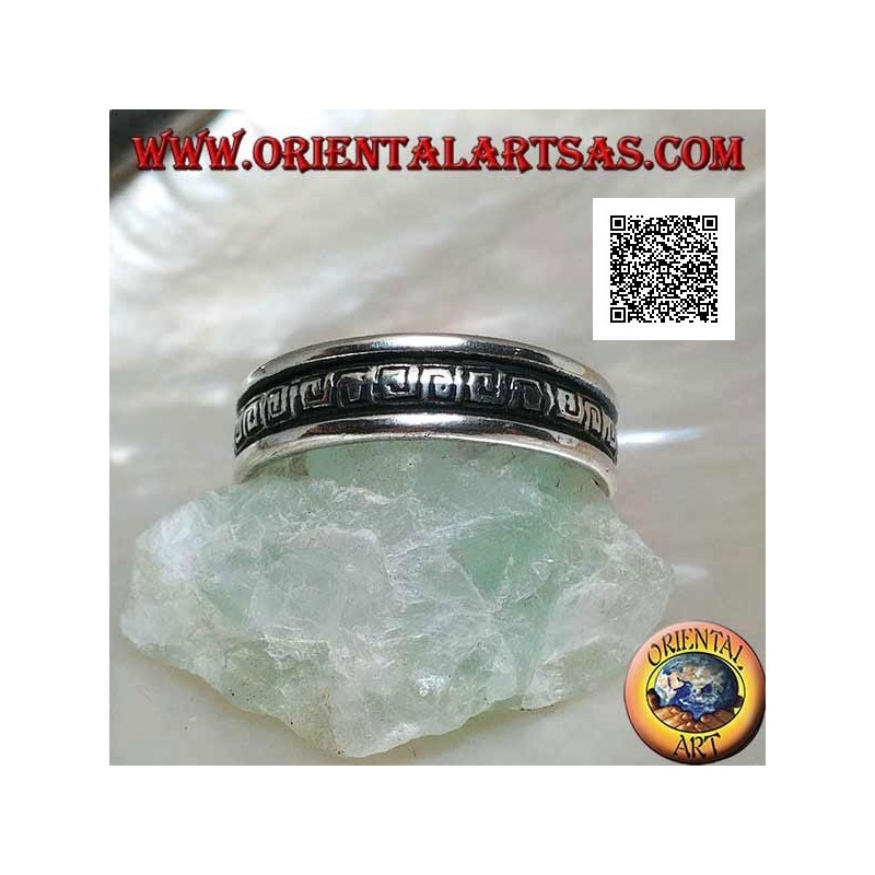 Silver wedding ring with a series of spiral labyrinths engraved in the central part