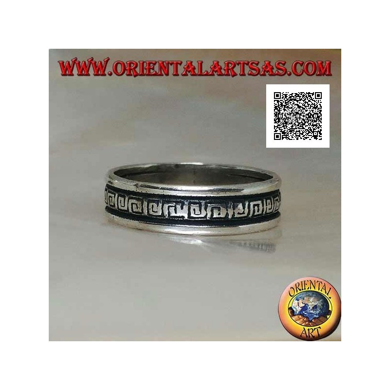 Silver wedding ring with a series of spiral labyrinths engraved in the central part