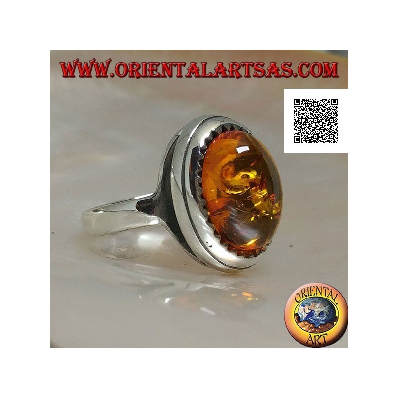 Silver ring with raised oval cabochon amber surrounded by triangles