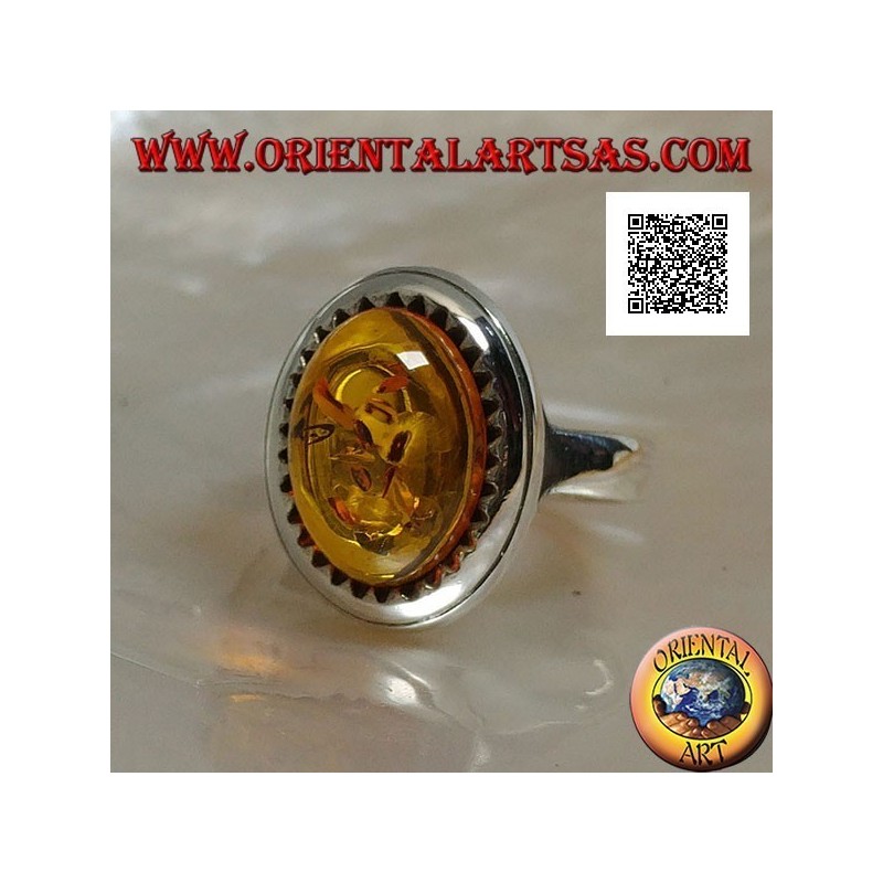 Silver ring with raised oval cabochon amber surrounded by triangles