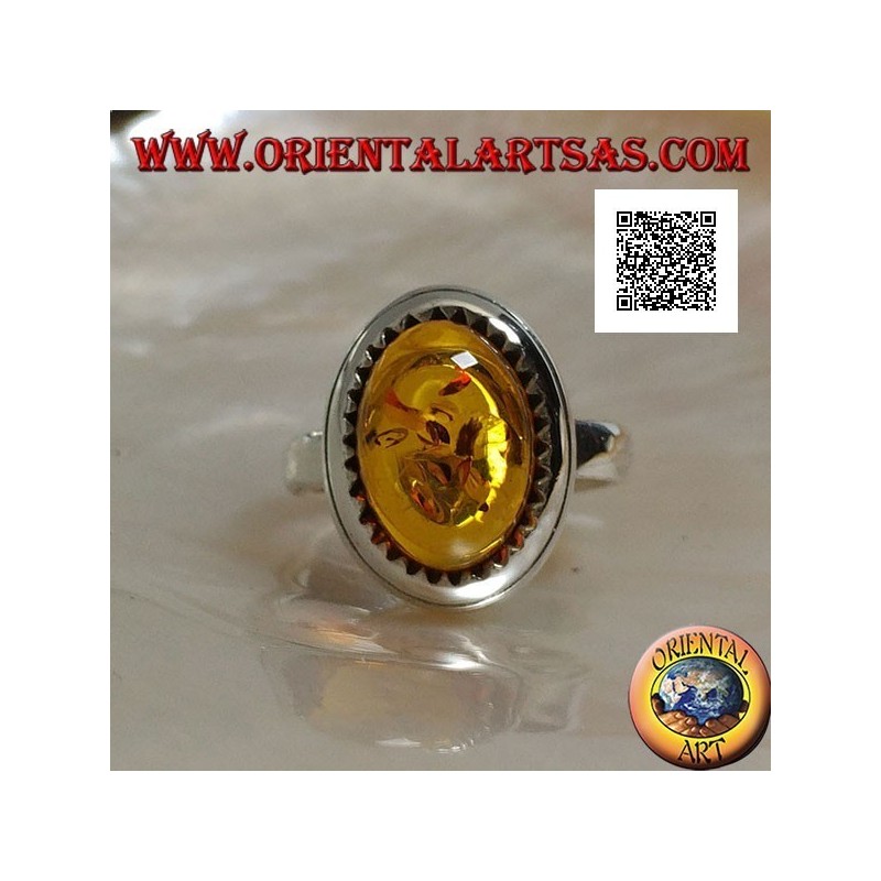 Silver ring with raised oval cabochon amber surrounded by triangles
