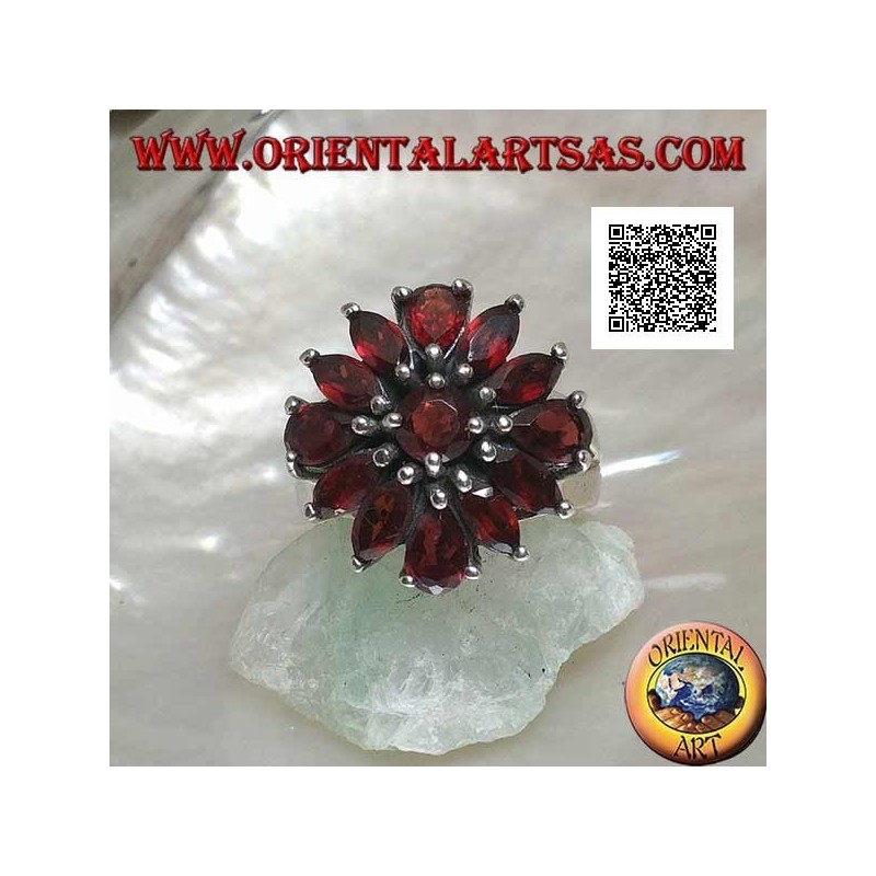 Silver ring with raised flower of 13 natural round, shuttle and drop shaped garnets, set