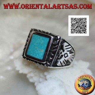 Silver ring with raised rectangular turquoise and bas-relief eagle on the sides