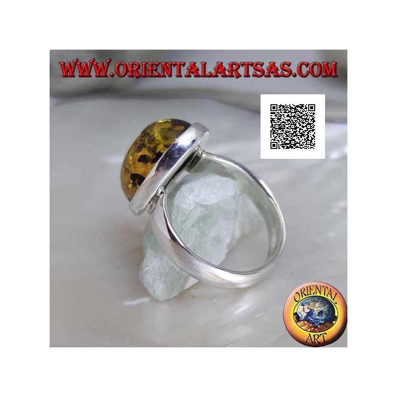 Silver ring with oval cabochon green amber on simple setting and smooth edge