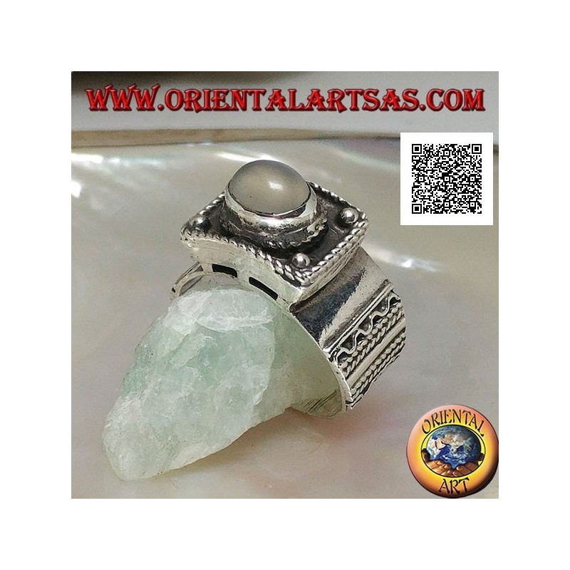 Silver band ring with raised cabochon oval moonstone and ethnic decorations