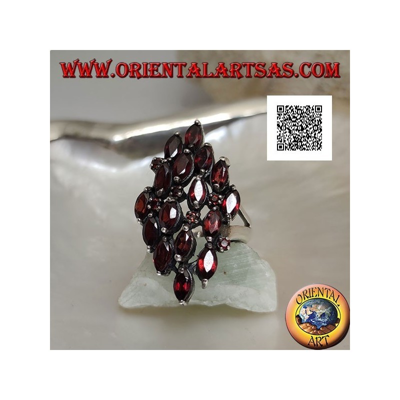 Rhomboidal silver ring with 16 shuttle garnets alternating with small round garnets