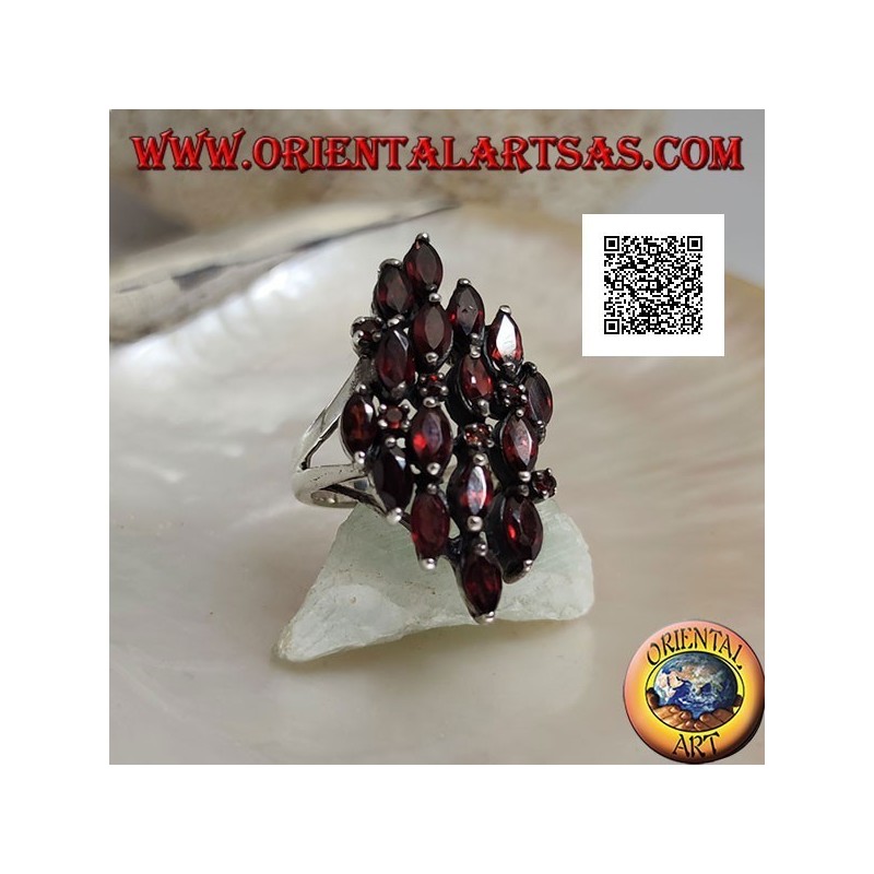 Rhomboidal silver ring with 16 shuttle garnets alternating with small round garnets
