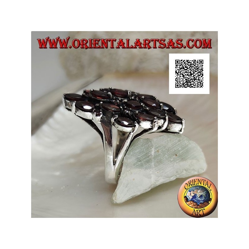 Rhomboidal silver ring with 16 shuttle garnets alternating with small round garnets
