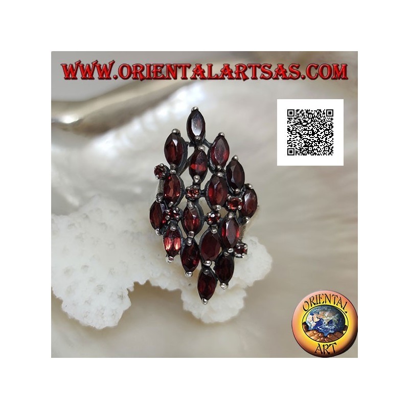 Rhomboidal silver ring with 16 shuttle garnets alternating with small round garnets