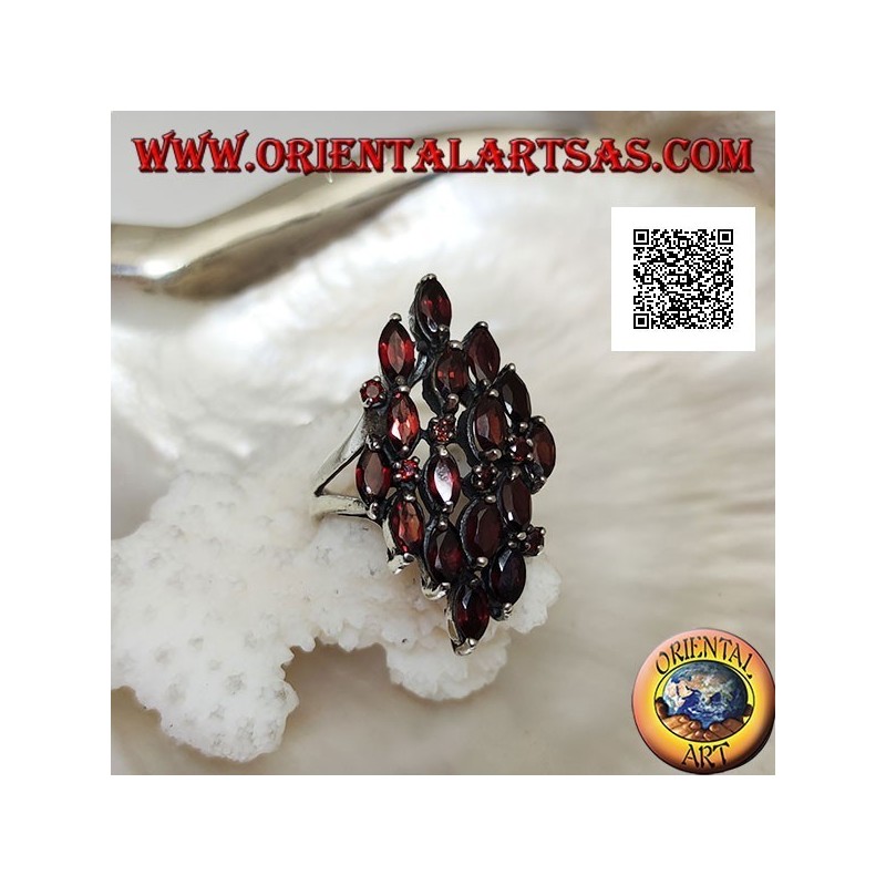 Rhomboidal silver ring with 16 shuttle garnets alternating with small round garnets