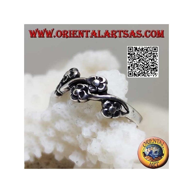 Silver ring with pairs of small flowers on a wavy line