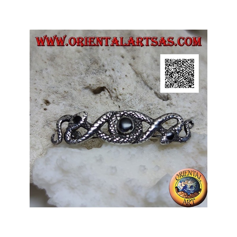 Broche de plata en forma de dos serpientes entrelazadas con ónix central y en los ojos