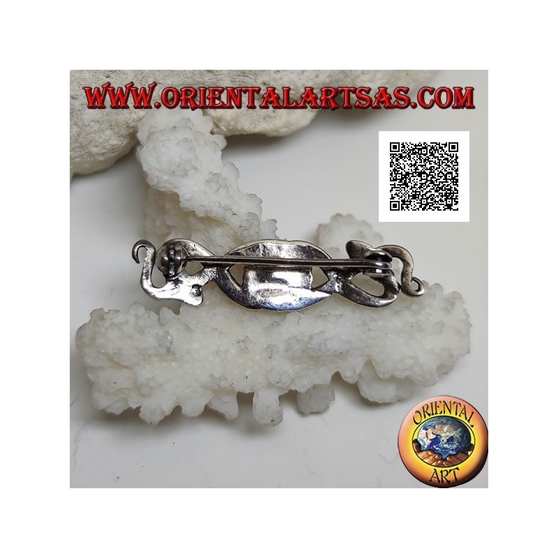 Broche en argent en forme de deux serpents entrelacés d'onyx central et sur les yeux