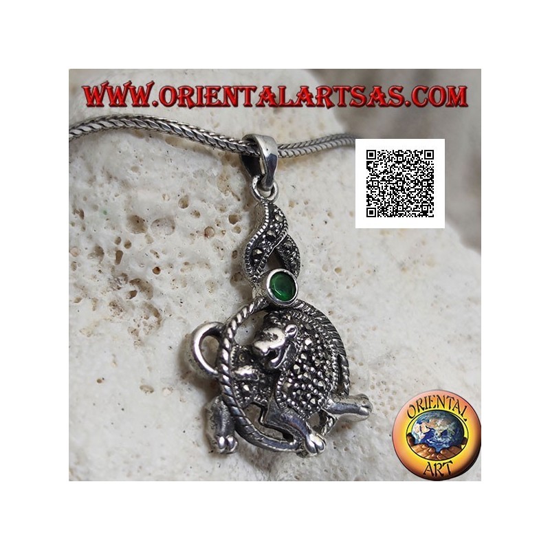 Silver pendant in the shape of a lion in the circle with mane and mantle studded with marcasite and green zircon above