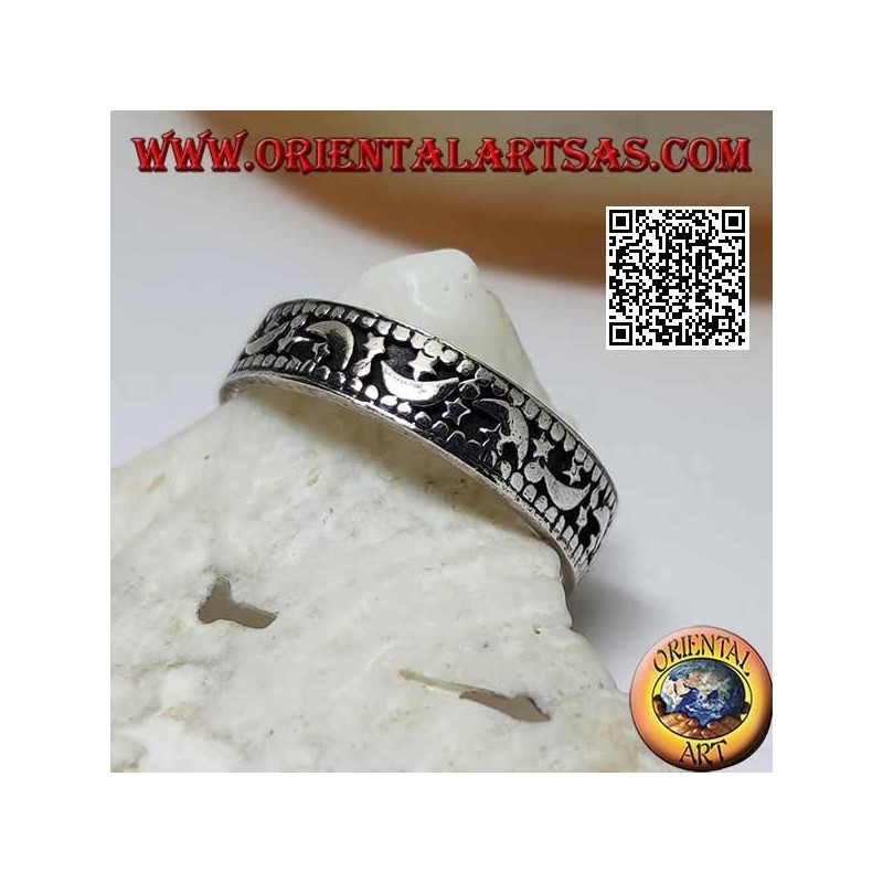 Silver ring with moons and stars on a hollowed background