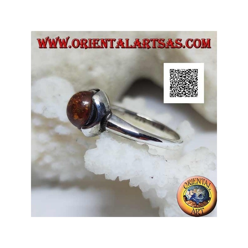 Silver ring with round cabochon amber surrounded by semicircles on a smooth setting