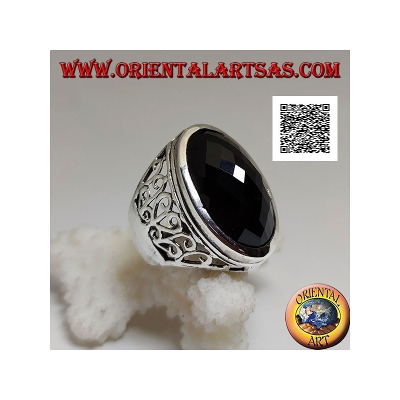 Silver ring with large oval faceted onyx and wavy openwork decoration on the sides